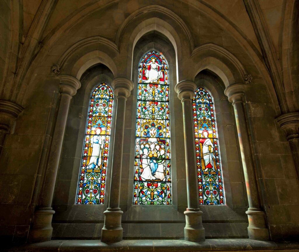 Sunlight streaming through stained-glass windows at Christ Church Cathedral, Dublin.